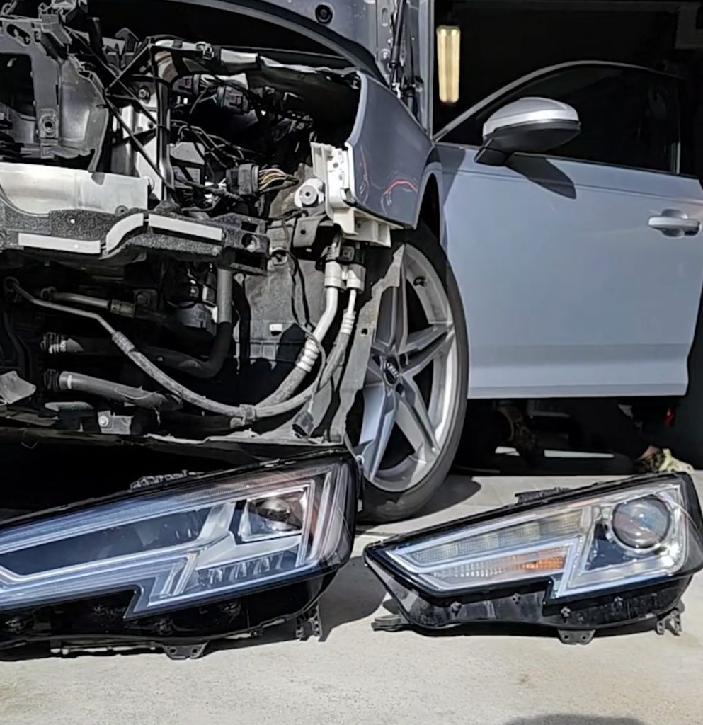Full LED headlight (left) next to the original Xenon headlight (right) on the ground in front of the car
